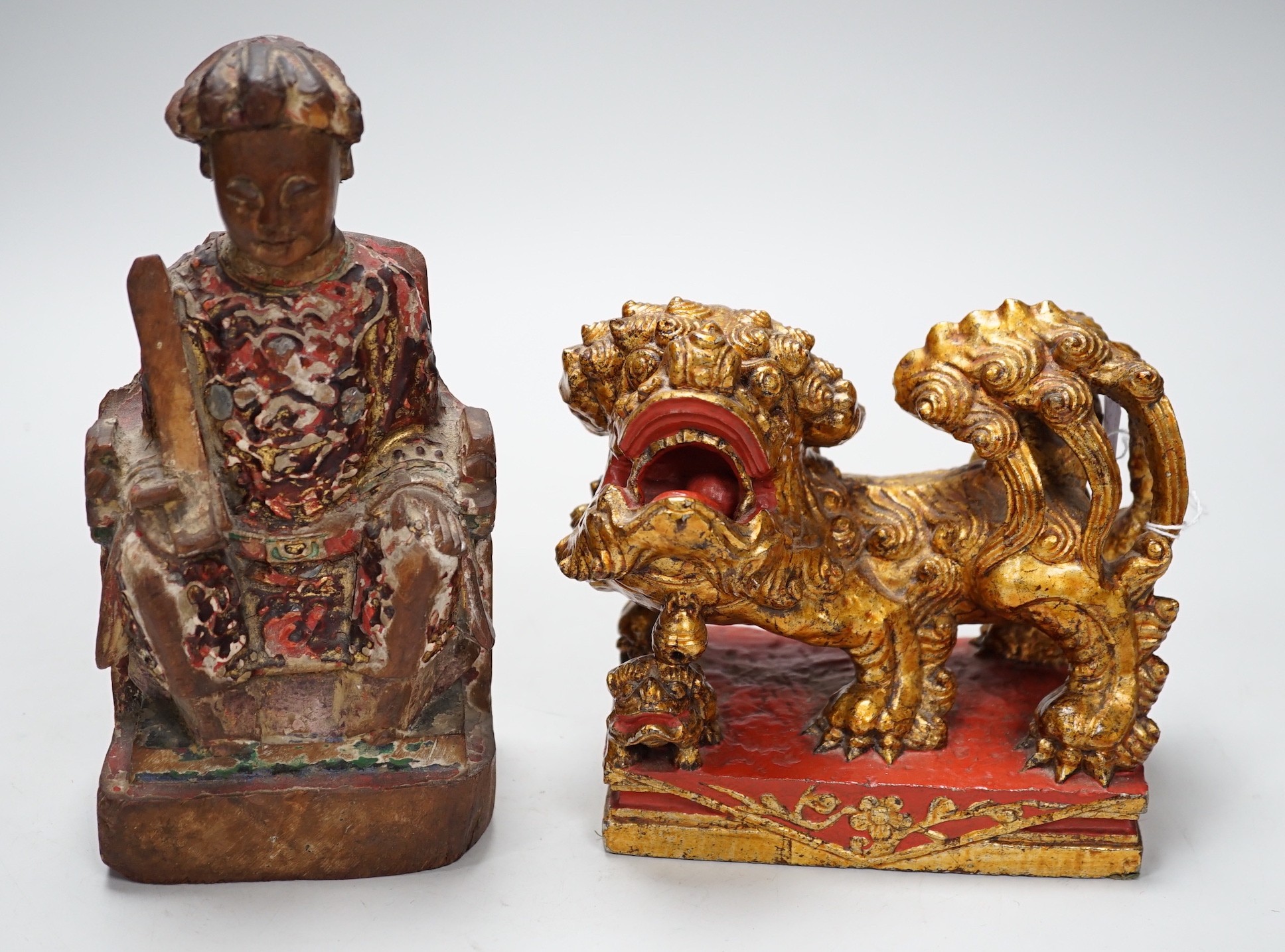 A Chinese lacquered wood figure of a seated woman and a Buddhist lion, tallest 20.5cm